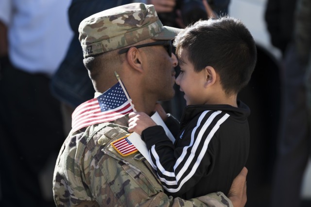 Staff Sgt. Robert Chavez, a signal support systems specialist with the 3631st Signal Company, reunites with his children at the Rio Rancho Readiness Center Nov. 15, 2022, following a 10-month deployment to the Central Command Area of...