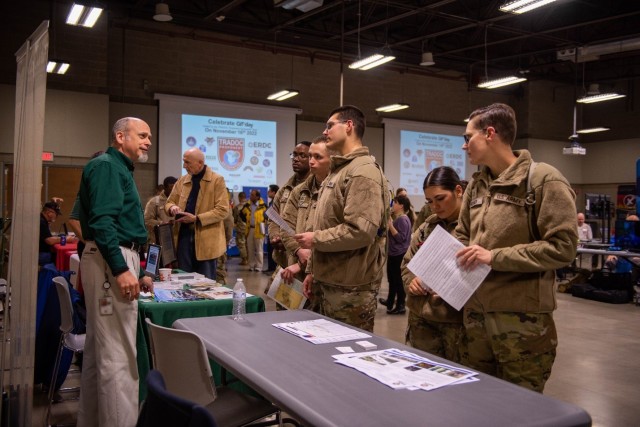Soldiers with Company B, 169th Engineer Battalion, engage with staff from the U.S. Geological Survey to learn about how the organization utilizes geographical information systems software during a GIS Day celebration held Wednesday at Danner Hall. 