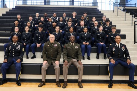 Lt. Col. Derek Bergman, center left, and Lt. Col. Terrance Wilson spent time with members of the Athens High School, Alabama, Golden Eagles JROTC Battalion after speaking about military service and patriotism at the Athens High School Veterans Day Program. Also pictured are battalion instructors, at far left, 1st Sgt. (retired) Leonard Long and, at far right, Chief Warrant Officer 4 (retired) James Chambers. (U.S. Army Photo by Alyssa Crockett)