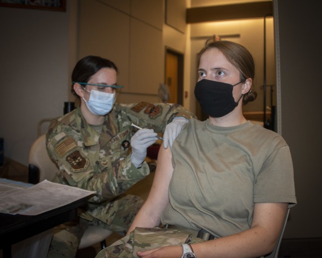 Air Force Senior Airman Kasey Ginn, medical technician, administers the COVID-19 vaccine to Army Capt. Christine Kasprisin, physical therapist, at Brooke Army Medical Center, Fort Sam Houston, Texas, Jan. 26, 2021. The San Antonio Military Health System is starting the next phase of the Department of Defense’s COVID-19 vaccine rollout -- expanding the scope of who is eligible to get vaccinated against the virus. (U.S. Army photo by Jason W. Edwards)