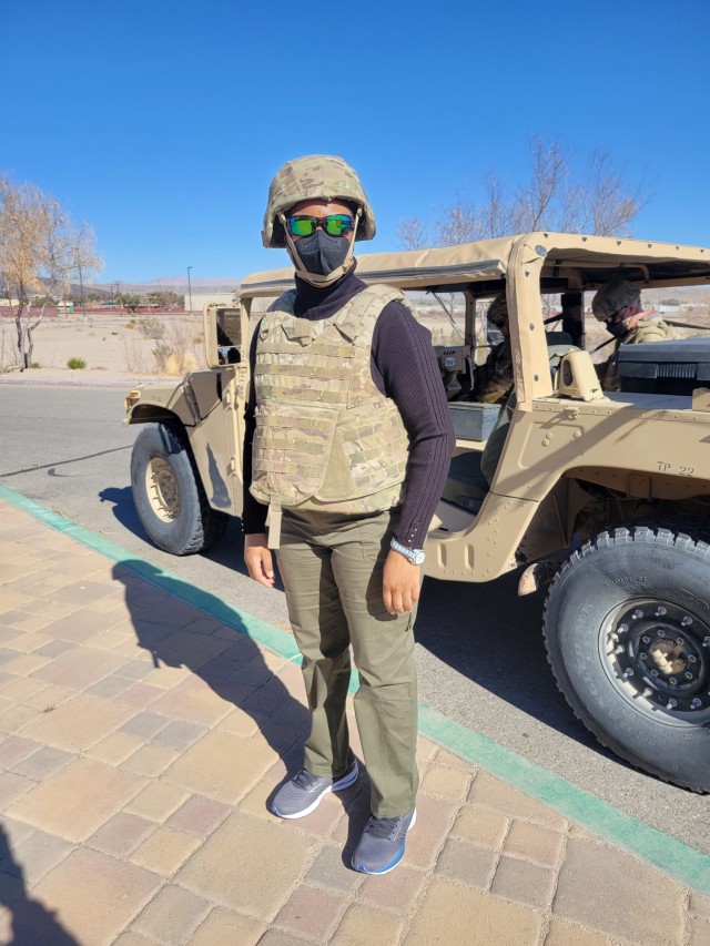 Quintessa Thomas, MH-60 subject matter expert for the Special Operations Aircraft Division in DEVCOM Aviation and Missile Center’s Systems Readiness Directorate, dons protective gear for her visit to the National Training Center.