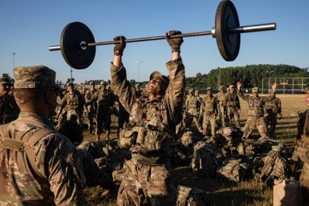 Soldiers assigned to the 1st Battalion, 502nd Infantry Regiment, 2nd Brigade Combat Team, 101st Airborne Division (Air Assault), conduct squat/shoulder press during the Talon Blitz II competition on July 22, 2022, at Mihail Kogalniceanu, Romania.