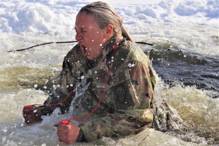 A Soldier participates in cold water immersion training at Big Sandy Lake on Fort McCoy, Wis., Jan. 31, 2022.