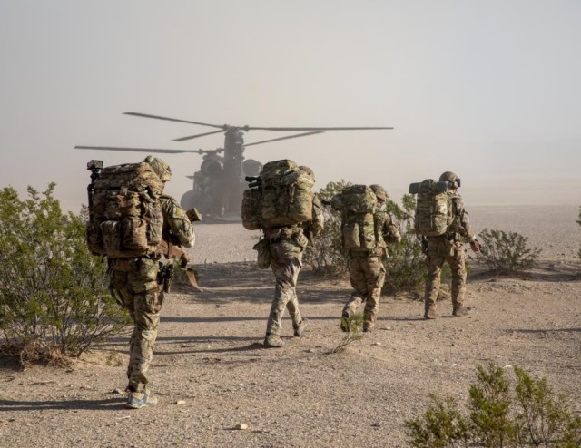 U.S. Soldiers and British Rangers board a Chinook at Project Convergence 22.