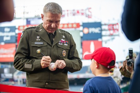 Chief of Staff of the U.S. Army Gen. James C. McConville signs a baseball for a fan during Army Day with the Nationals at Nationals Park in Washington, D.C., June 16, 2022. Secretary of the U.S. Army Christine Wormuth, Gen. McConville and Sgt. Maj. of the U.S. Army Michael A. Grinston hosted the Army’s 247th birthday celebrations. 