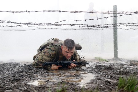 Spc. Patrick Kusik, an indirect fire infantryman assigned to 1st Battalion, 111th Infantry Regiment, 56th Stryker Brigade Combat Team, 28th Infantry Division, Pennsylvania Army National Guard low crawls under barbed wire while navigating an individual movement technique lane April 23 at Fort Indiantown Gap, Pa. Kusik attended a four-day Ranger Sapper Assessment Program and the IMT lane was an evaluated event. This event was designed to prepare the trainees for the infamous Malvesti obstacle course, a wet and muddy confidence course that they will encounter if selected to attend Ranger School. 
