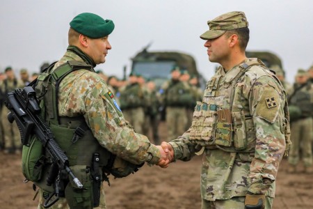 U.S. Army Sgt. 1st Class Daniel Navarro, first sergeant of Ares Company, 1st Battalion, 66th Armor Regiment, 3rd Armored Brigade Combat Team, 4th Infantry Division receives a coin from Command Sgt. Maj. Ruslanas Gulevas, command sergeant major of the Lithuanian Armed Forces Algirdas Battalion during the closing ceremony of Exercise Iron Wolf 22 at Pabradė Training Area, Lithuania, Oct. 28, 2022.

The 3rd Armored Brigade Combat Team, 4th Infantry Division  is among other units assigned to the 1st Infantry Division, proudly working alongside NATO allies and regional security partners to provide combat-credible forces to V Corps, America&#39;s forward deployed corps in Europe.