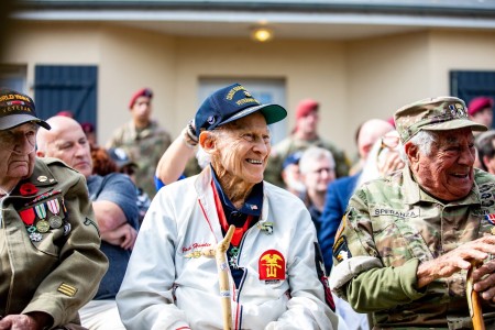 World War II veterans attend a ceremony at the Eternal Heroes Memorial in Normandy, France, June 2, 2022, to honor fallen paratroopers who liberated Ravenoville in June 1944. Veterans and representatives of veterans who could not be there received challenge coins during the event.