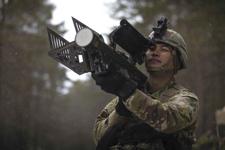 Army Sgt. Uelle Ballares aims a man-portable air-defense system during Rising Griffin, an exercise to maintain readiness, at Pabrade Training Area, Lithuania, April 6, 2022.