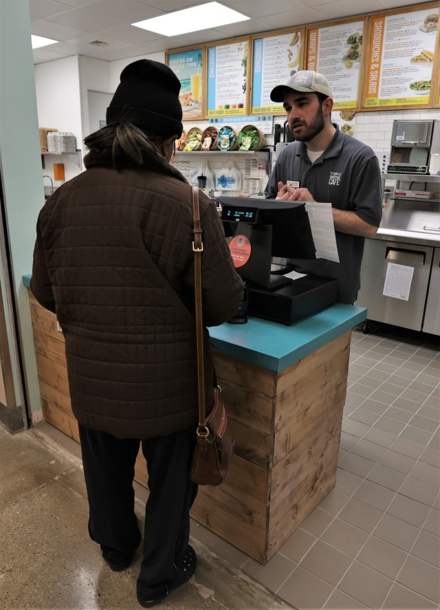 The first customer of the newly opened Tropical Smoothie Café in the Fort Knox Exchange food court places her order Dec. 1, 2022, following the restaurant’s ribbon cutting ceremony.