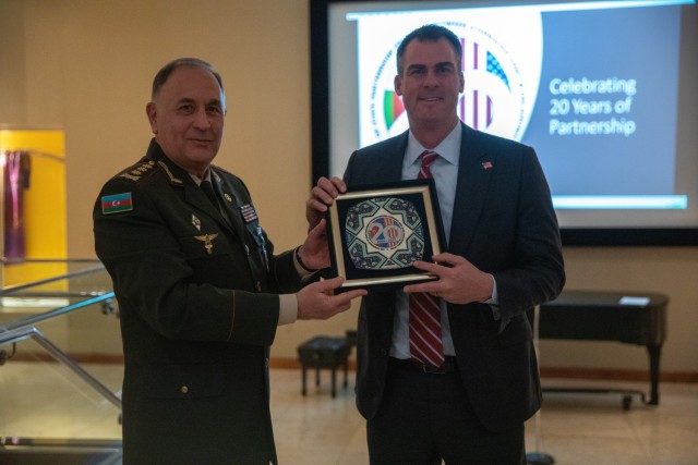 Col. Gen. Karim Valiyeva, first deputy minister of defense and chief of the general staff of the Azerbaijan Army, presents a gift to Oklahoma Gov. Kevin Stitt at the Oklahoma City Museum of Art Nov. 30, 2022. Oklahoma National Guard leaders and a...