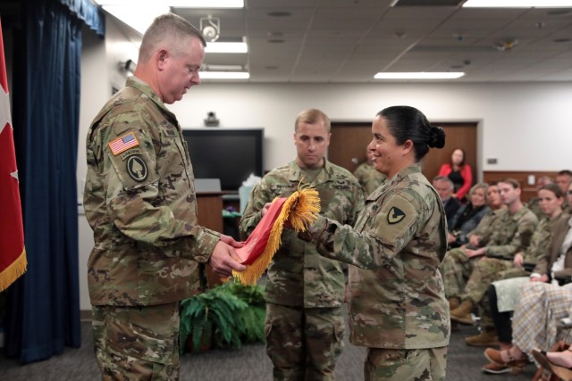 Army Materiel Command Deputy Commanding General and Redstone Arsenal Senior Commander Lt. Gen. Chris Mohan unfurls the three-star flag, supported by Sgt. Maj. Samara Pitre and Sgt. 1st Class Robert Peters during his promotion ceremony.