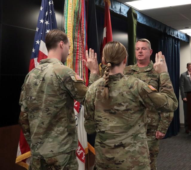 Newly promoted Lt. Gen. Chris Mohan, Army Materiel Command deputy commanding general and Redstone Arsenal senior commander, recites the oath of office, administered by his son Capt. Tom Mohan and daughter 2nd Lt. Molly Mohan, during his promotion...