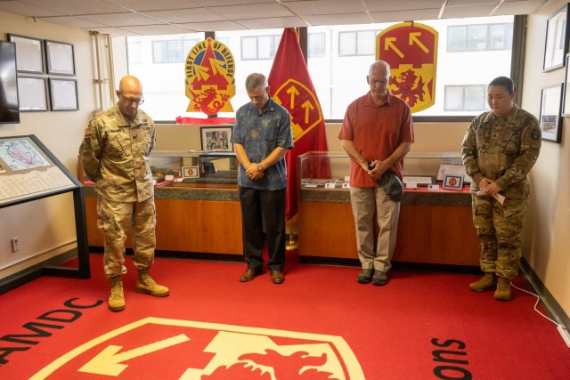 Col. Matthew Dalton, Col. (R) John Hansen, Col. (R). Chris Moylan, and SGT Grace Lee observe a moment of silence