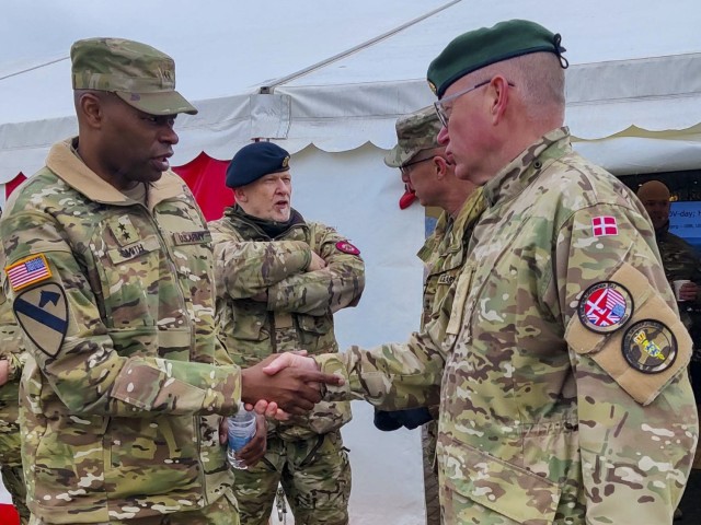 Maj. Gen. James M. Smith, commander, U.S. Army 21st Theater Sustainment Command, shakes hands with Denmark Lt. Col. Claus Klaris, officer in
charge of port operations at the port of Esbjerg, Denmark, on April 6, 2022. 