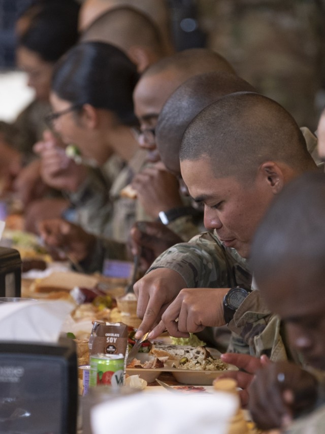 Trainees with Company B, 3rd Battalion, 34th Infantry Regiment, chow down on their Thanksgiving meal, Nov. 23.