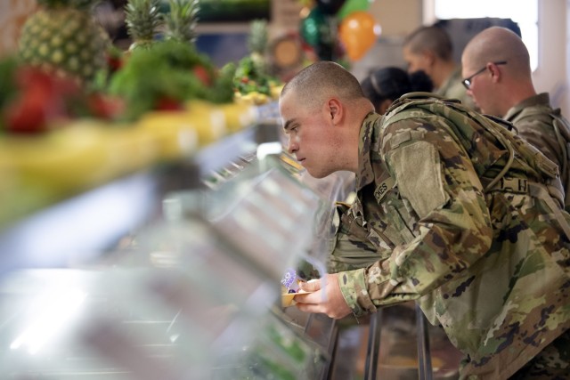 A trainee with Company B, 3rd Battalion, 34th Infantry Regiment reaches for food on the salad bar during his Thanksgiving meal, Nov. 23 on Fort Jackson. The meal was served by unit leadership, cadre and drill sergeants.