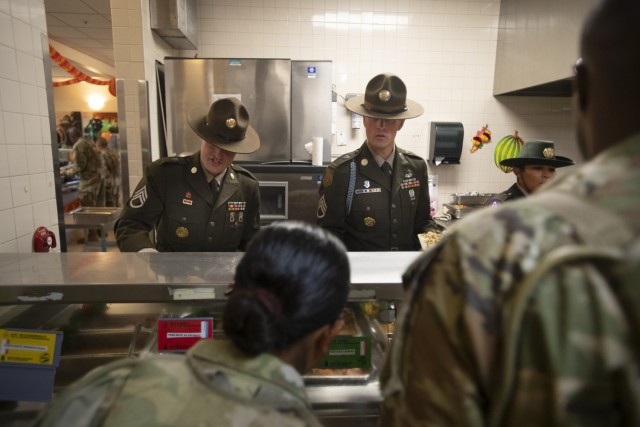 Drill sergeants serve a Thanksgiving meal to trainees of Company B, 3rd Battalion, 34th Infantry Regiment, Nov. 23. The installation began serving holiday meals to the troops a day early.