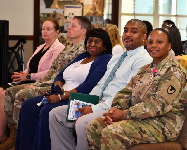 (L to R) Deputy to the Garrison Commander Yvette L. Castro; Deputy Garrison Commander Lt. Col. Brian Mandock; Col. Seaberry’s family, her mother Ms. Miller; her husband, Robert Seaberry and Outgoing Garrison Commander Col. Tomika M. Seaberry.