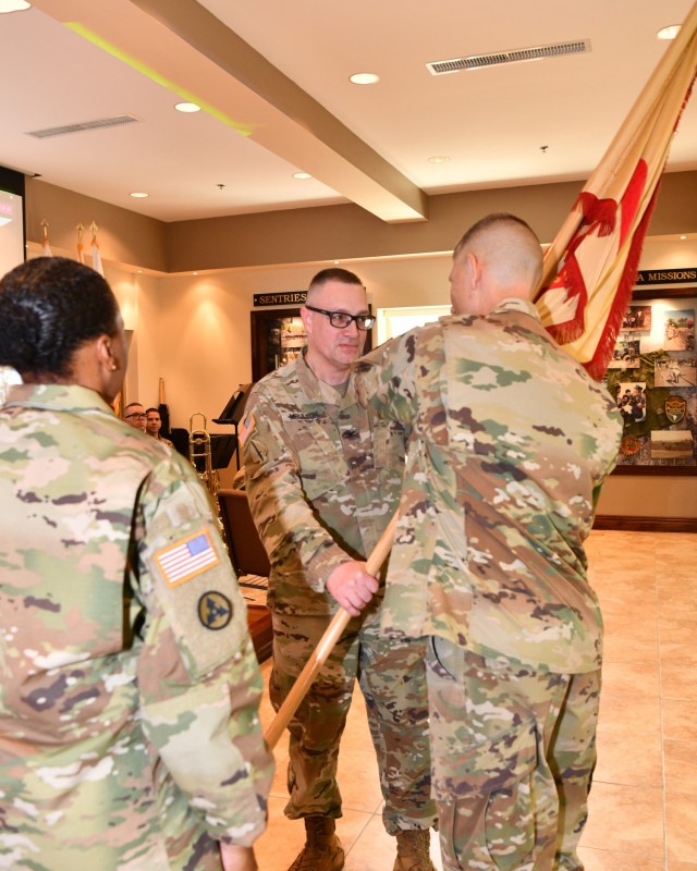 New Fort Buchanan Garrison Commander Col. Charles N. Moulton passes the colors to Command Sgt. Maj. Hendricks symbolizing his first official act with the Garrison Command Sergeant Major and his trust in the unit’s Noncommissioned Officer Corps,...