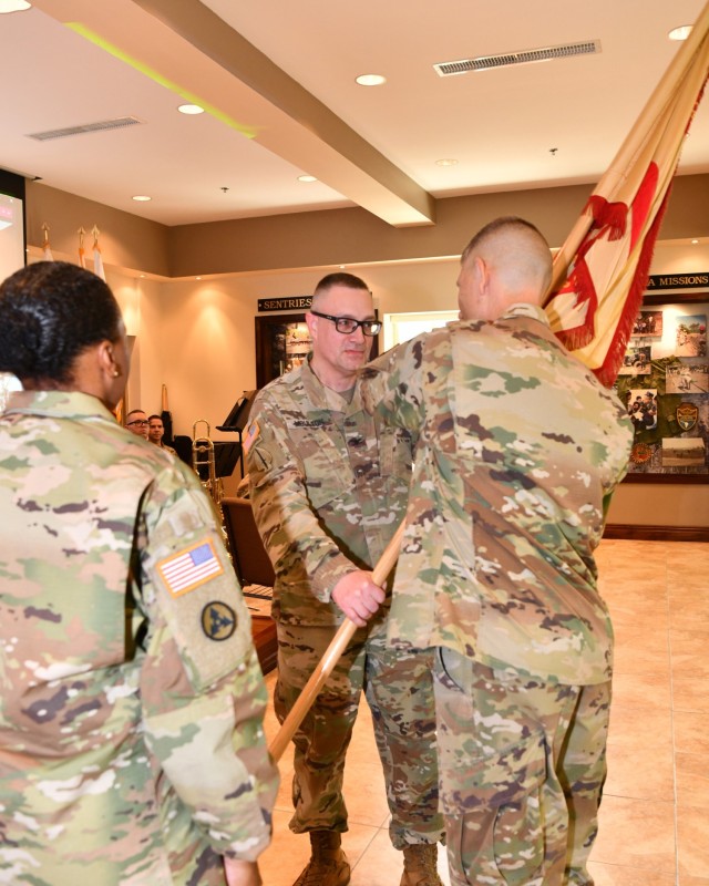 New Fort Buchanan Garrison Commander Col. Charles N. Moulton passes the colors to Command Sgt. Maj. Hendricks symbolizing his first official act with the Garrison Command Sergeant Major and his trust in the unit’s Noncommissioned Officer Corps, completing the Change of Command.