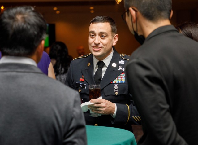Command Sgt. Maj. David A. Rio, senior enlisted leader of U.S. Army Garrison Japan, speaks with Japanese counterparts during a holiday reception at the Camp Zama Community Club, Japan, Dec. 9, 2022. 