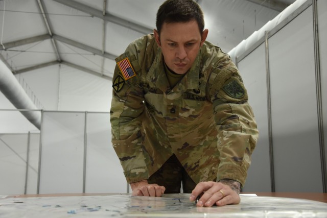 Sgt. 1st Class Aaron Welch, NRDC-Spain G3, updates the corps’ map based on real-time input during Exercise Loyal Leda 2022 in Bydgoszcz, Poland. The 10-day combat readiness evaluation exercise hosted at the NATO Joint Force Training Centre was an Allied Land Command-sponsored, land domain, tactical level, virtual command post exercise held from Nov. 30 to Dec. 9.