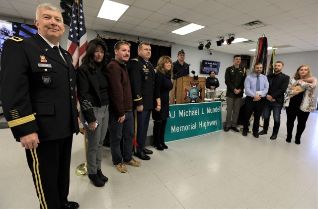 Commanding General of Army Reserve Aviation Command Brig. Gen Roger Deon (left) stands with Gold Star Family members of fallen Soldier Maj. Michael Mundell at the Dec. 10, 2022 dedication ceremony to rename a portion of state Highway 1638 in honor...
