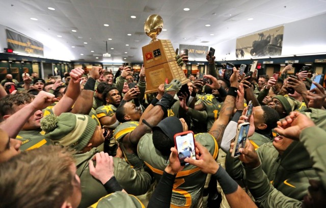 The Army Black Knights celebrate with the Secretary&#39;s Trophy after beating the U.S. Naval Academy 20-17, Dec. 10, 2022. 