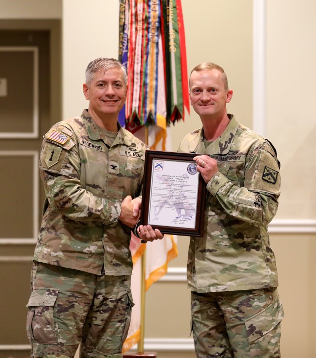 Combined Arms Center-Training’s Deputy Commander Col. Scott Woodward presents CAC-T’s new Senior Enlisted Advisor Sgt. Major Christopher Kohunsky with the Assumption of Responsibility Charter during a ceremony Dec. 13, 2022 at the Frontier Conference Center, Fort Leavenworth, Kan. Photo by Tisha Swart-Entwistle, Combined Arms Center-Training Public Affairs.