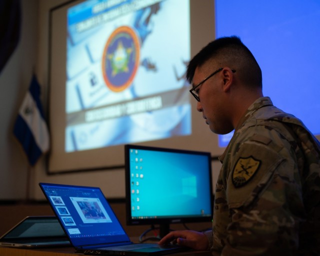 Sgt. Adam Dorian Wong, a threat researcher with 136th Cybersecurity Unit, presents new topics of interest including artificial intelligence and vulnerability identification to the Salvadoran cybersecurity unit in San Salvador, El Salvador, Dec. 7, 2022. The new material was targeted toward the Salvadoran team’s goals and vision. (U.S. Air National Guard photo by Staff Sgt. Victoria Nelson)