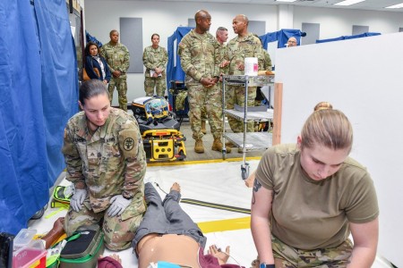 Lt. Gen. Milford Beagle, commanding general, U.S. Army Combined Arms Center observes combat paramedic students training while being briefed by Maj. Gen. Michael Talley, commanding general, U.S. Army Medical Center of Excellence (MEDCoE) during a visit to Joint Base San Antonio-Fort Sam Houston, Texas, December 14, 2022.