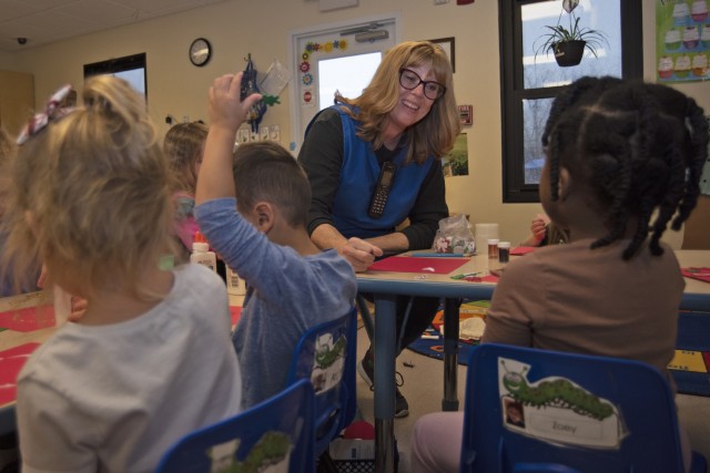 Barbara Melton interacts with preschool children Tuesday at Child Development Center 408. Melton is one of Fort Leonard Wood’s Child Youth Services employees who is not a military dependent or retiree, and now has provisional Commissary shopping...