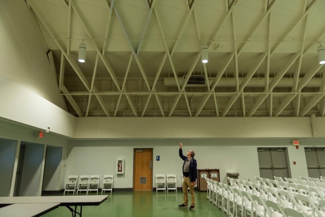 Nutter Field House Facility Coordinator Tod Davidson points to an example of some of the aluminum sheathing already installed to encapsulate the wood beams that make up the facility’s roof truss system Friday. The World War II-era building will...