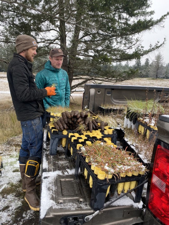 Leif Wefferling, left, Range and Training Land Assessment coordinator, and Joey Burgess, Plant Propagations manager, discuss planting plan in the snow Nov. 29.