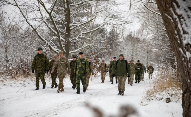 U.S. Army Maj. Gen. John V. Meyer III, commander of the 1st Infantry Division (1 ID), walks alongside armed forces officers from Estonia, Finland, Lithuania, Poland and Sweden during Winter Strike 22, a command post exercise held in Bolesławiec, Poland, Dec. 12, 2022. The 1 ID is working alongside NATO allies and regional security partners to provide combat-credible forces to V Corps, America’s forward deployed corps in Europe.