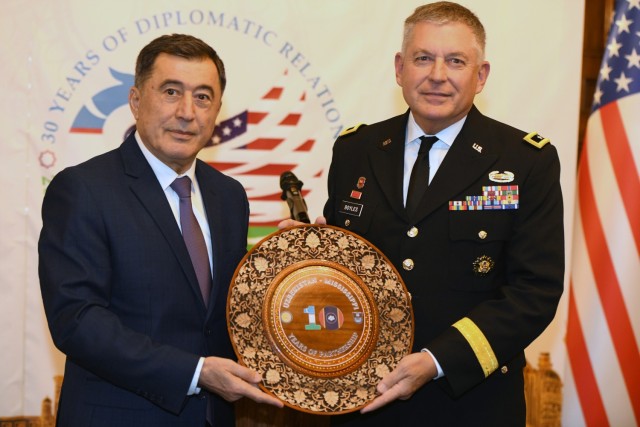 Army Maj. Gen. Janson D. Boyles, the adjutant general of the Mississippi National Guard, showcases a traditional wood plate presented from Uzbekistan Foreign Minister Vladimir Norov during a reception at the Embassy of the Republic of Uzbekistan in Washington Dec. 12, 2022. The Guard and Uzbekistan celebrated the 10-year anniversary of their partnership under the Defense Department National Guard Bureau State Partnership Program.  (U.S. Air National Guard photo by Master Sgt. Erich B. Smith)