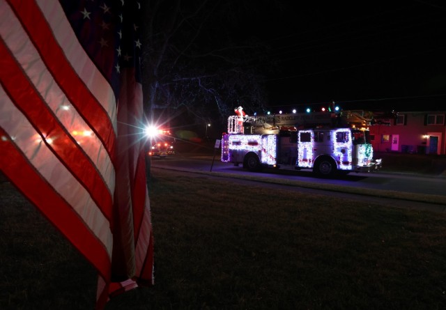 Santa waves to Knox Hills residents from atop a Christmas light-covered fire truck Dec. 20, 2022, during his second tour through Fort Knox neighborhoods.