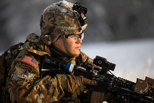 Spc. Megan Koszarek, an infantryman with the Alaska Army National Guard’s Avalanche Company, 1st Battalion, 297th Infantry Regiment, conducts a security sweep during a training exercise near Joint Base Elmendorf-Richardson, Alaska, Dec. 3, 2022. The exercise&#39;s aim was to enhance the unit’s combat readiness and evaluate proficiency in an arctic environment.
