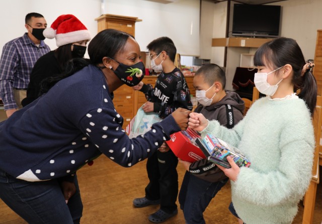 First Sgt. Alfrelina Wynn, a member of the U.S. Army Japan Sergeant Audie Murphy Club, says goodbye to children at the Seikou Gakuen children&#39;s home in Zama, Japan, Dec. 21, 2022. Soldiers donated gifts from the Camp Zama community to children at the home as part of an outreach effort.