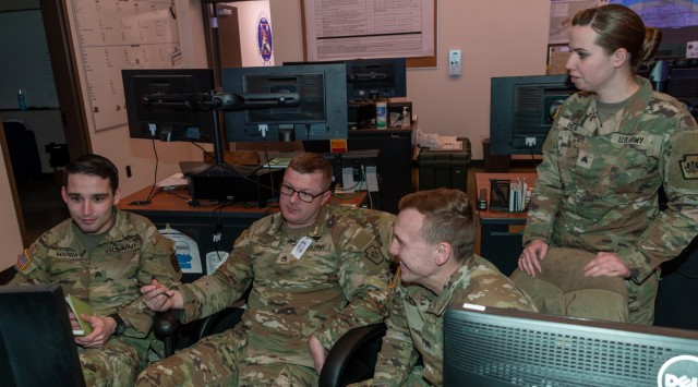 Pennsylvania National Guard Joint Operations Center operations noncommissioned officers Sgt. John Marru, Staff Sgt. James R. Ergott, Sgt. Christopher R. Galbraith and Sgt. Kelly Heil, participate in a winter storm tabletop exercise from the JOC floor Dec. 20, 2022, at Fort Indiantown Gap, Pa. The exercise designed to improve and validate domestic response procedures. (This photo was altered to obscure an ID card.)