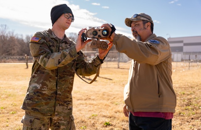 PEO Soldier NET Team Lead Hands Over LTLM II Device to Soldier