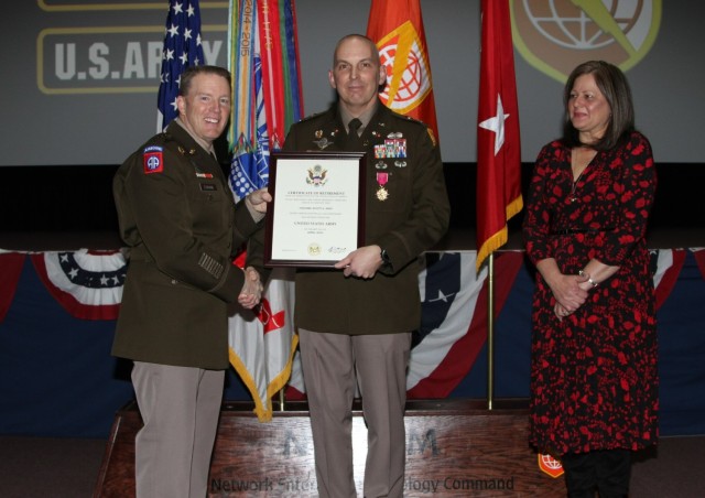 Col. Scott Bird, NETCOM Deputy Commander for Operations, receives his retirement certificate