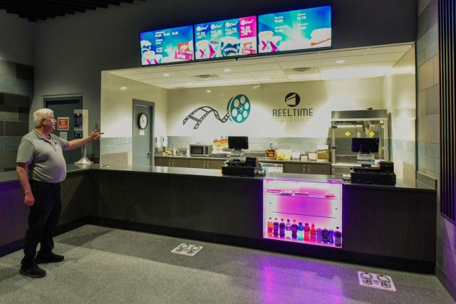 Keith Lurie, Abrams Theater supervisor, points to the new snack bar, installed as part of a floor-to-ceiling renovation of the theater. Among many other upgrades are new seats with cup holders, an improved sound system and a digital projector.