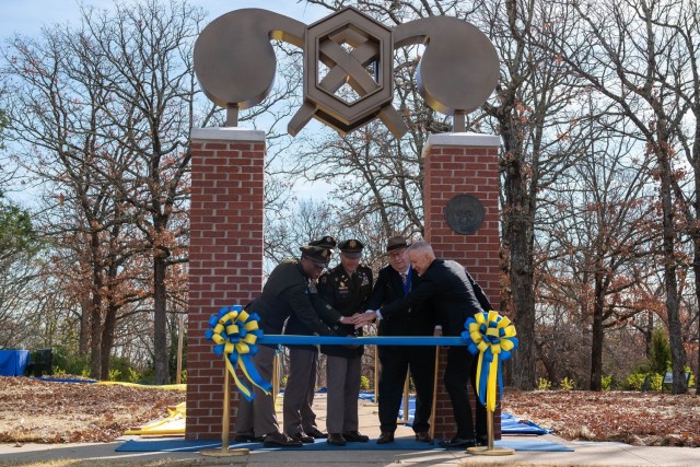 From left: U.S. Army Chemical, Biological, Radiological and Nuclear School Regimental Chief Warrant Officer 3 Humphrey Hills II, USACBRNS Regimental Command Sgt. Maj. Raymond Quitugua Jr., USACBRNS Commandant Col. Sean Crockett, Dr. John Thiel,...