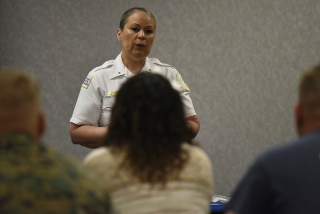 Deputy Chief Migdalia Bulnes, from the Chicago Police Department’s recruitment and retention unit, speaks with transitioning service members and their dependents June 4 in Bldg. 470, during a CPD hiring fair hosted by the Fort Leonard Wood...