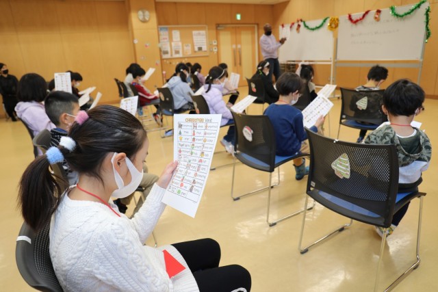 Rodney Holloway has Japanese students recite English words during a free lesson at the Oyama Community Center in Sagamihara, Japan, Dec. 22, 2022. Holloway, an English for Speakers of Other Languages teacher at Arnn Elementary School, often volunteers his time to teach English in the local community.