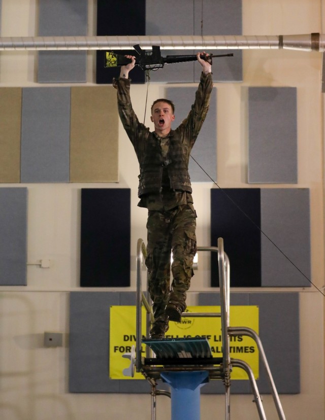 FORT CARSON, Colo.-- Spc. Tyler Gravem, with 1st Battalion, 38th Infantry Regiment, 4th Infantry Division, participated in the annual 4th Inf. Div. Best Ranger competition, jumping off the high diving board as part of the swim test Dec. 14, 2022....