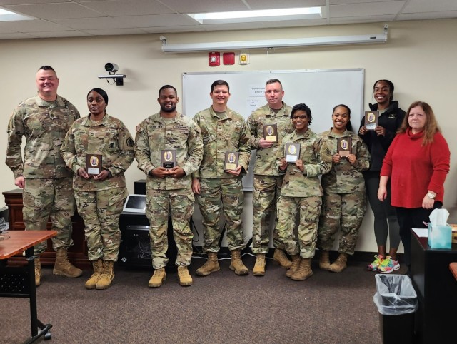 Fort Knox Garrison Command Sgt. Maj. William Fogle (left) stands with recent graduates of the Army Basic Skills Education Program Dec. 27, 2022 and instructor Lola Best (right). The class raised its overall average General Technical score from 98 to 123 upon completing the course.