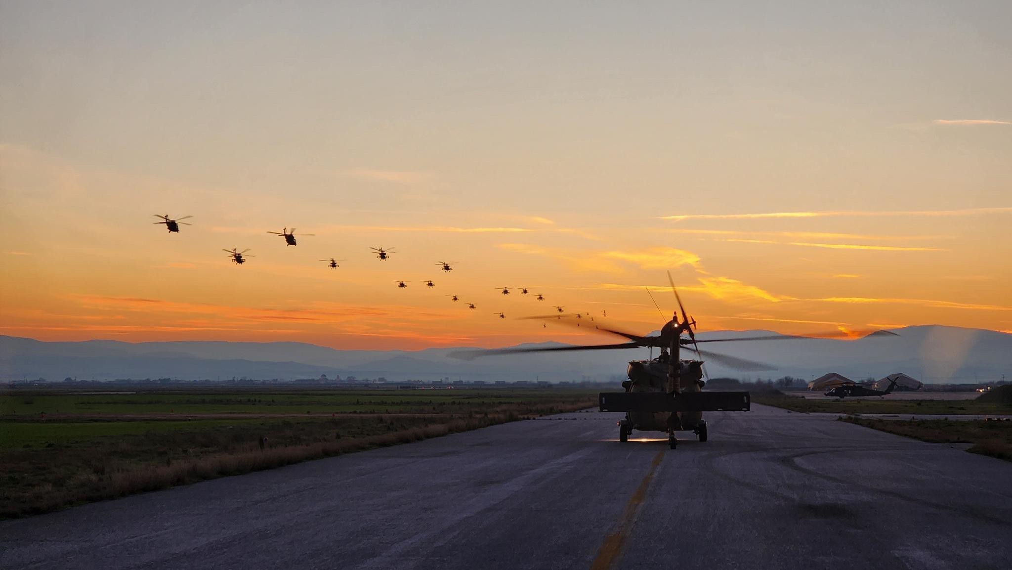 U.S. Army Soldiers from the 3rd Battalion, 6th Cavalry, Combat Aviation Brigade, 1st Armored Division — operationally controlled by the 1st Infantry Division — and soldiers of the Hellenic Army participate in a 26 aircraft elephant walk at Camp Perissaki, Greece, during a visit from Lt. Gen. Angelos Choudeloudis, 1st Hellenic Army commanding general, Dec. 27, 2022. 